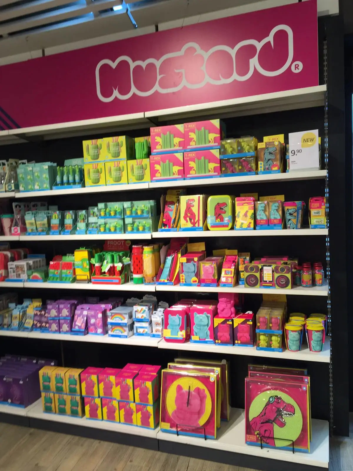 Colorful display of novelty desk accessories, stationery, and office gifts arranged on store shelves.
