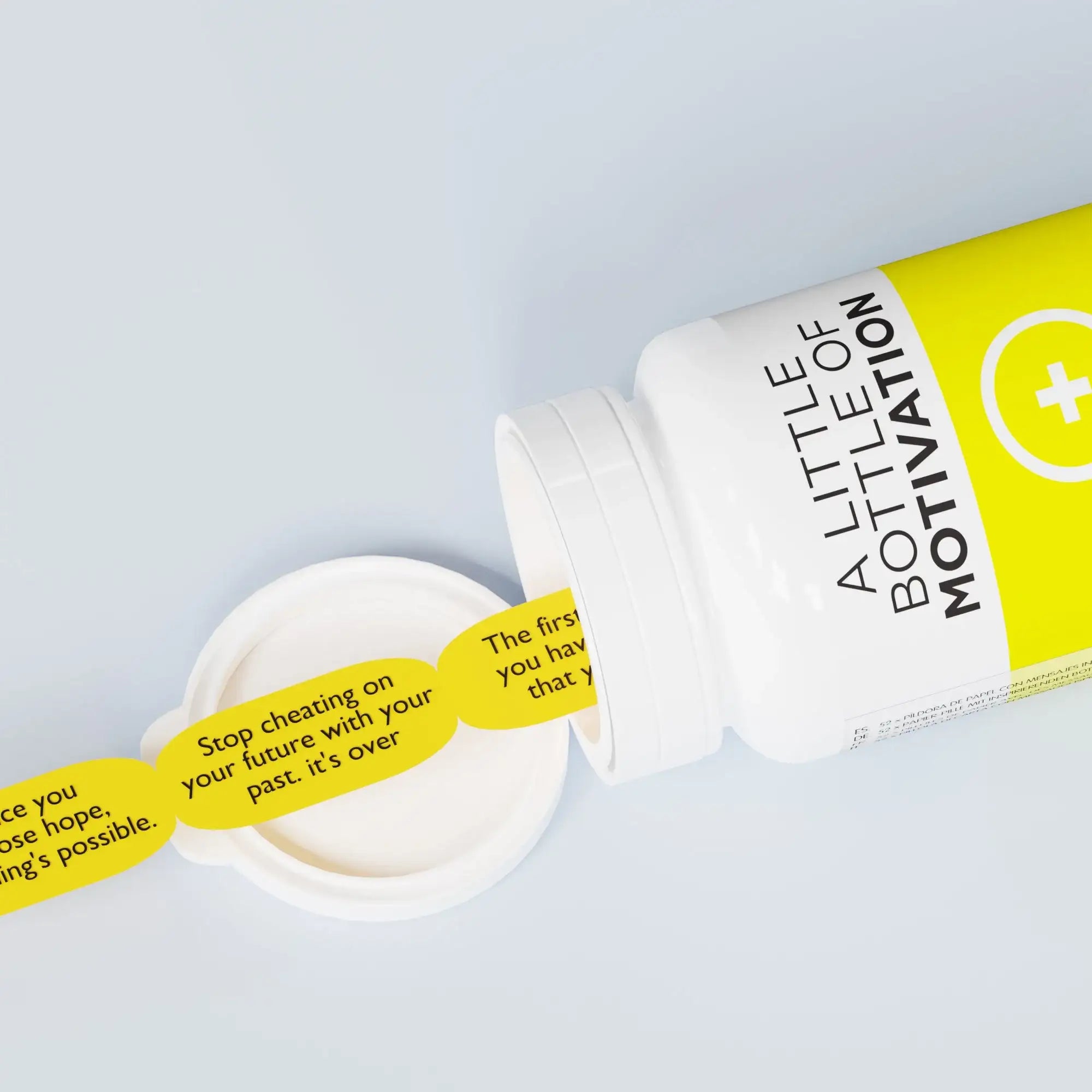 White and yellow bottle labeled 'A Little Bottle of Motivation' with motivational messages inside.